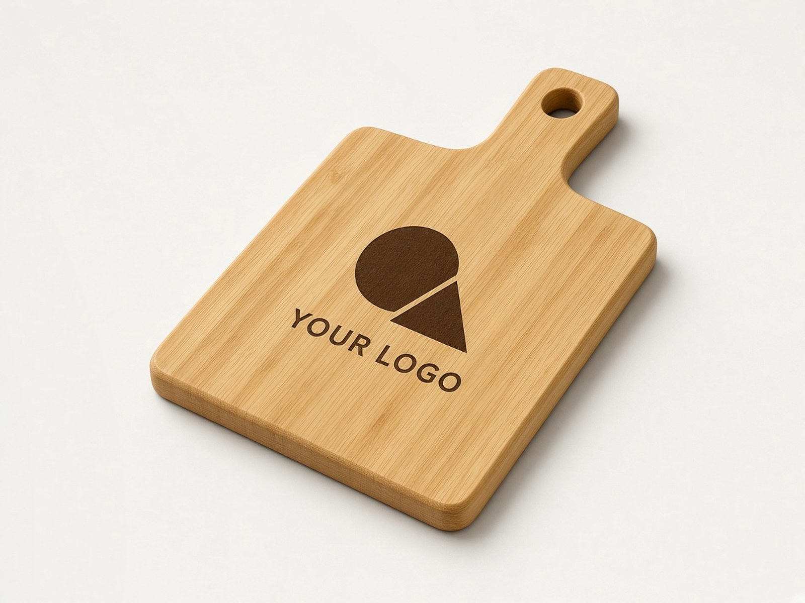 A bamboo serving board with a handle, engraved with an example logo.